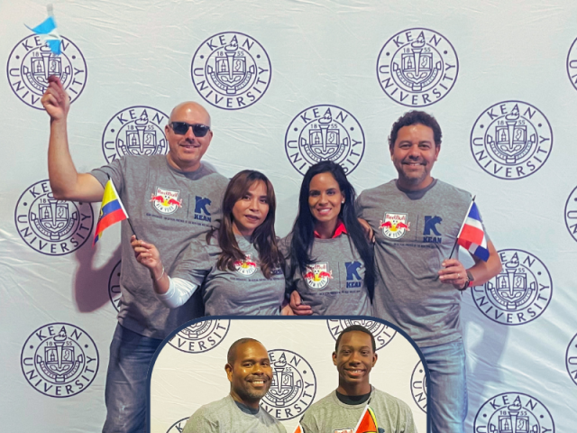 Alumni at Red Bulls Noche Latina in Grey t-shirts and with flags in hand